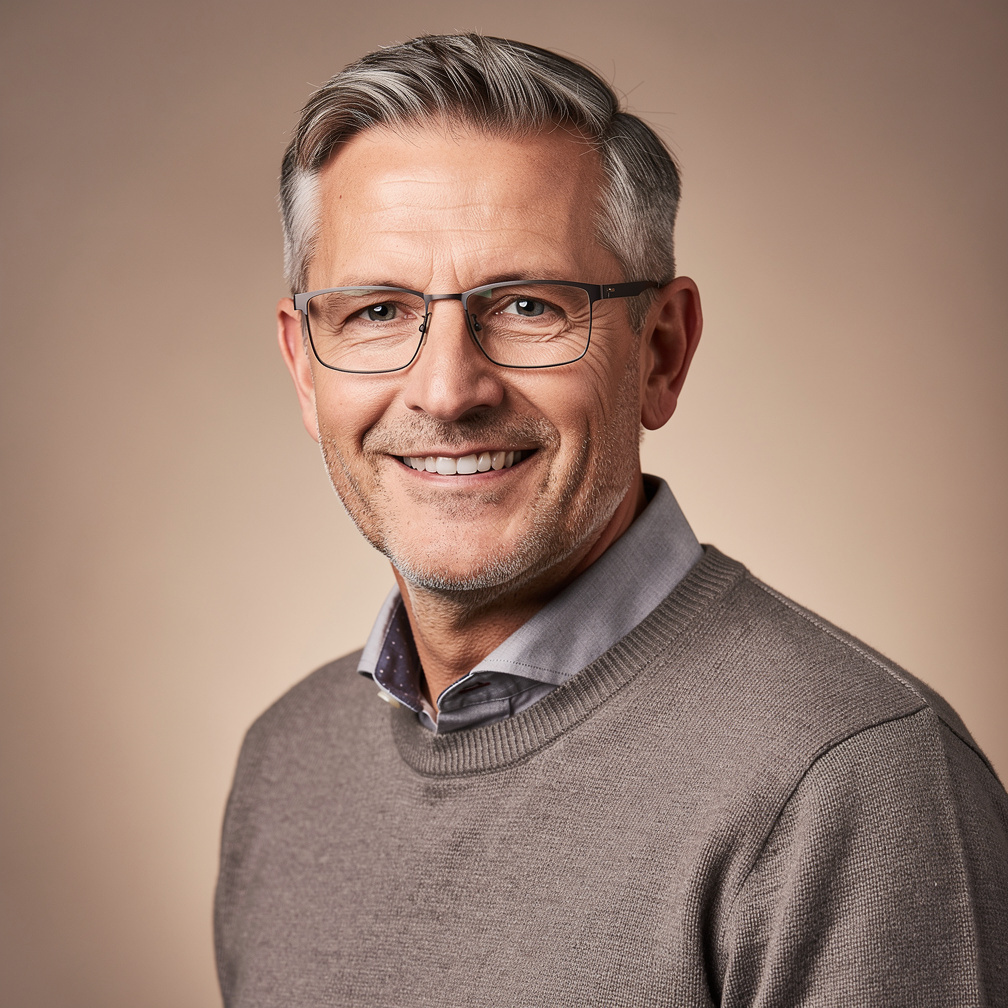 Portrait of a Swiss male journalist in his fifties wearing glasses